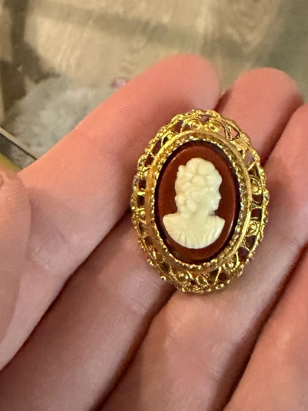 Gold-Tone 1970’s Cameo Brooch with White Relief on Brown Background
